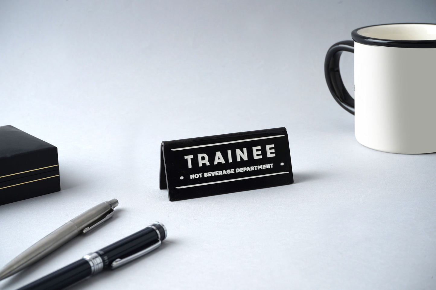 Black Acrylic Desk Sign 'Trainee Hot Beverage Department'