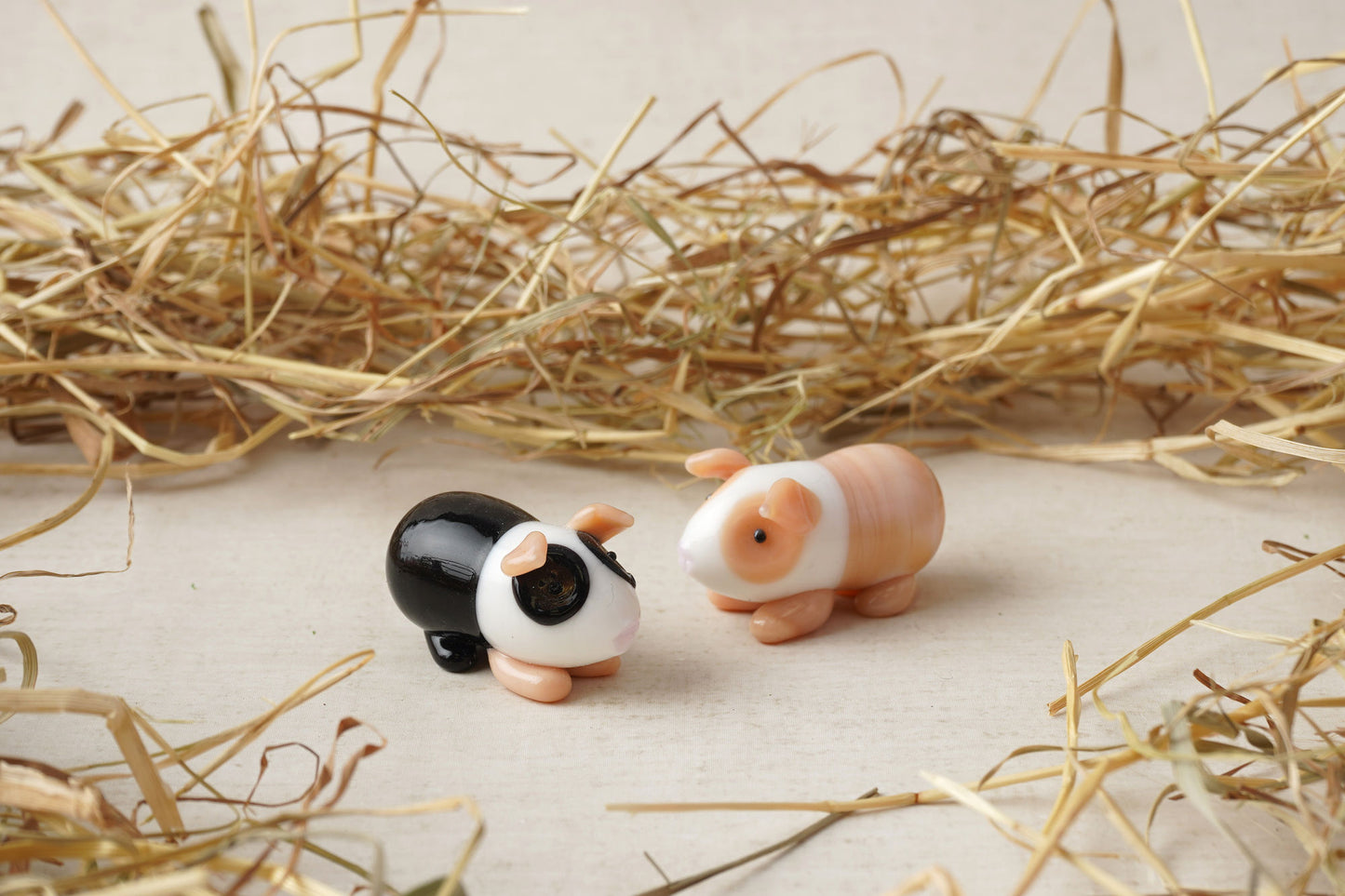 2 Assorted Glass Guinea Pigs