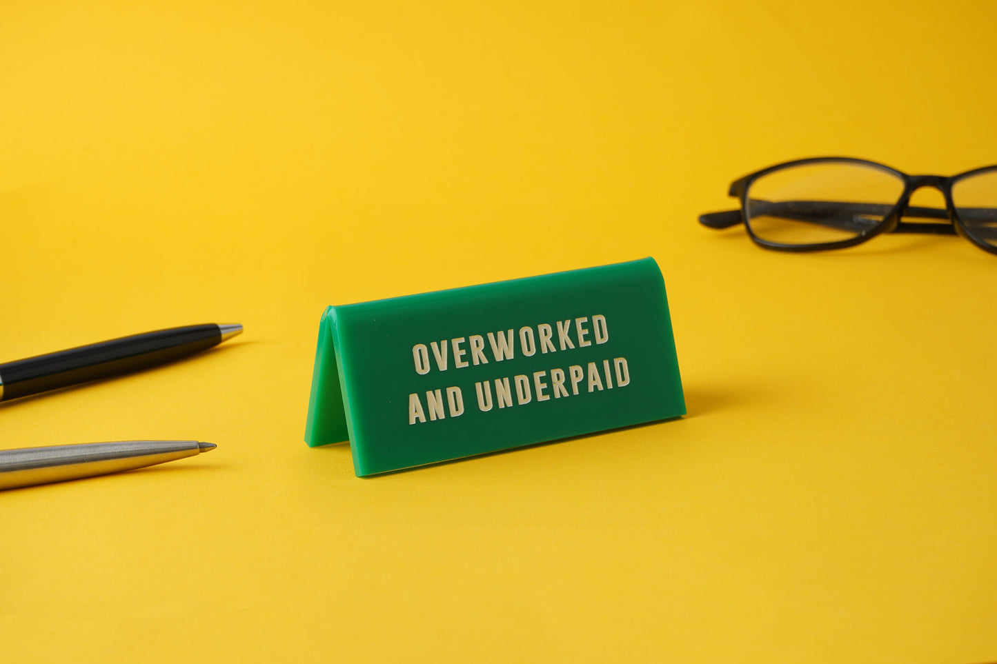 Green Acrylic Desk Sign 'Overworked And Underpaid'
