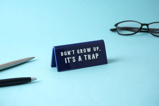 'Don't Grow Up, It's a Trap' Blue Desk Sign