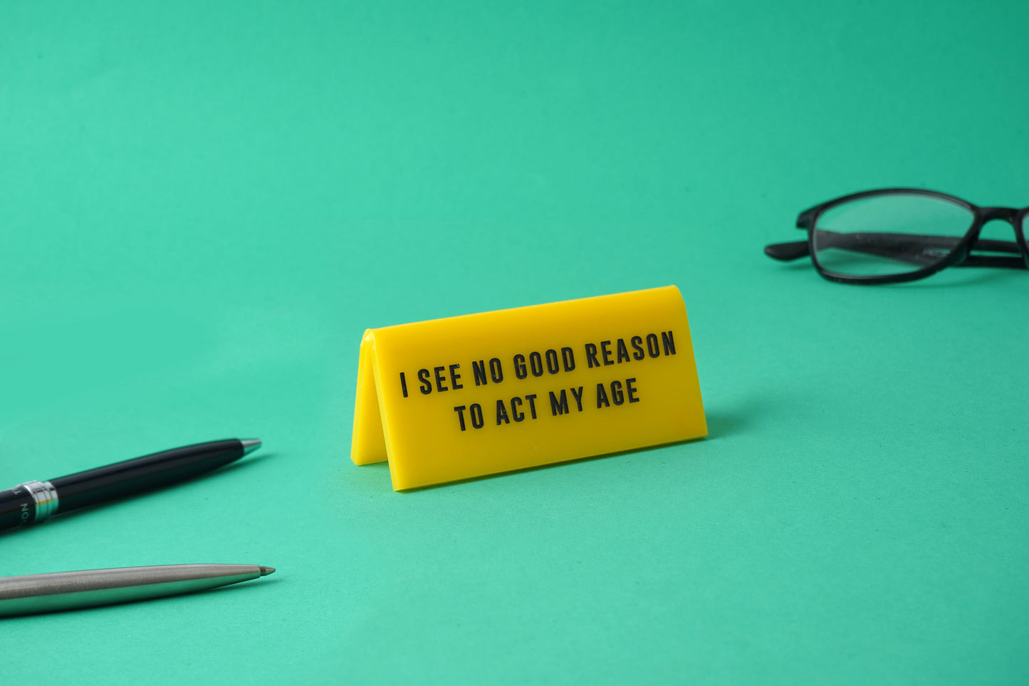 'No Good Reason To Act My Age" Yellow Desk Sign